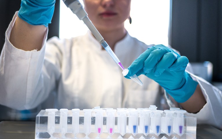 Female scientist pipetting colored chemicals into a tube._Julia Koblitz_unsplash_julia-koblitz-RlOAwXt2fEA-unsplash.jpg