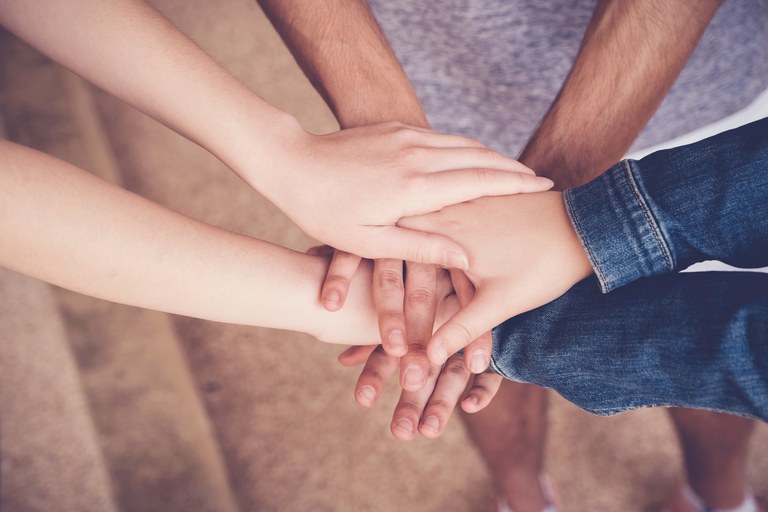 Multi ethnic hands of young adults putting hands together, volunteer and charity teamwork, initiative empower  collaboration community, all lives matter, equality, no to racism concept_Sewcream_AdobeStock_267497216.jpeg